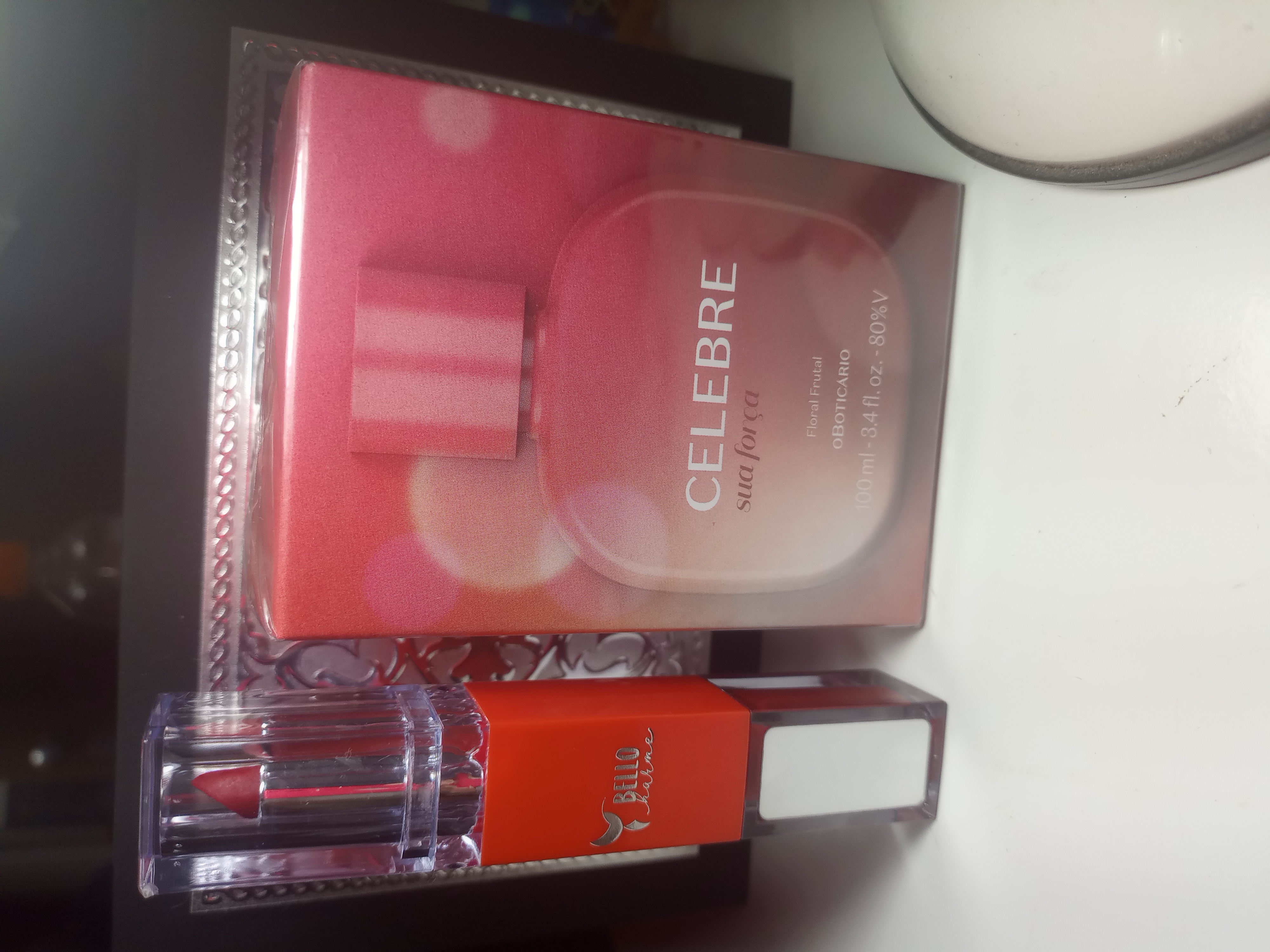 Um perfume boticário e um batom Bello harme